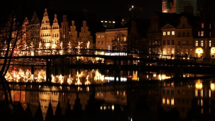 Sticker - Lübeck at night with view over the Trave river with festive Christmas lighting in winter