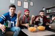 © Drobot Dean - Photo of guys fans eating chips and drinking beer while watching match