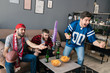 © Drobot Dean - Photo of guys eating chips and drinking beer while watching sports match