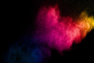 Wall Mural - colorful powder explosion on black background. abstract pastel color dust particles splash.