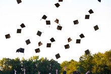 Graduates With Their Hats In Mid-air