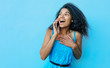 © My Ocean studio - Dazed and amazed. Surprised African American girl with messy raven black hair is posing with her left hand on her chest while talking on her smartphone.