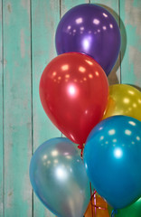 background of multicolored balloons and a beautiful wooden wall in pink and blue