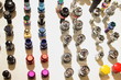 © Ilya - More rows multi colored wheel nuts and bolts on white backdrop close up, technical texture for background