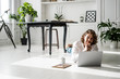 © Westend61 - Man lying on the floor at home using laptop