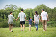 © Blue Jean Images - Happy Chinese family walking on grass