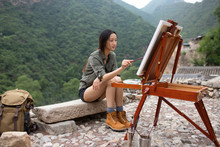 Young Chinese Woman Painting Outdoors