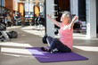 © Blue Jean Images - Senior Chinese woman stretching at gym