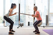 © Blue Jean Images - Senior Chinese woman working out with personal trainer at gym
