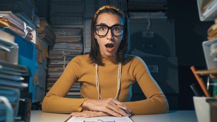 Wall Mural - Shocked businesswoman gasping and looking at camera