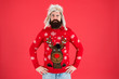 Buy festive clothing. Sweater with deer. Hipster bearded man wear winter sweater and hat. Happy new year. Join holiday party craze and host Ugly Christmas Sweater Party. Winter party outfit