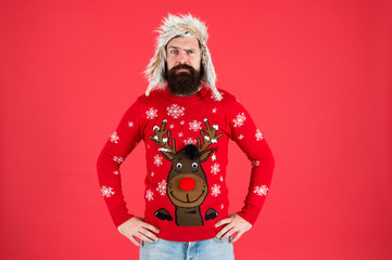 Wall Mural - Buy festive clothing. Sweater with deer. Hipster bearded man wear winter sweater and hat. Happy new year. Join holiday party craze and host Ugly Christmas Sweater Party. Winter party outfit