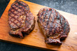 Traditional barbecue dry aged wagyu entrecote beef steak as top view on modern design wooden cutting board