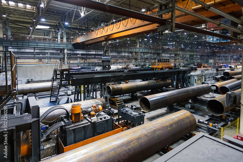 Fotografía Pipe factory production line, unfinished pipe moving on roller conveyor