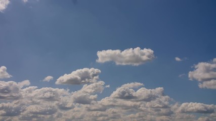 Wall Mural - Blue Skies with White Fluffy Clouds Moving Left to Right Slowly