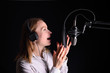 © Anton - Radio presenter working on the radio, with dramatic light.