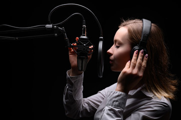 Singer, blogger, voice acting. Work in the studio with a studio microphone.