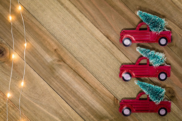 Christmas Holiday Winter still life concept on wooden board with vintage red truck and tree decor, flat lay room for text copy