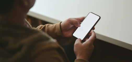 Canvas Print - cropped shot of man using blank screen smartphone in his modern workplace