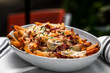 Nachos cheese loaded french fries - mexican cuisine, outside restaurant in a summer day  