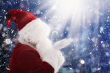 Fototapeta Do akwarium - Santa Claus with magic Christmas lights