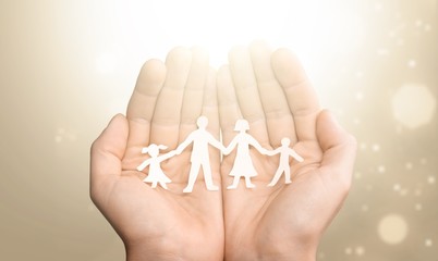 Poster - Love and relationships concept - closeup of man's cupped hands showing paper  family