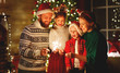 © JenkoAtaman - happy family mother, father and children celebrate Christmas and new year, light sparklers.