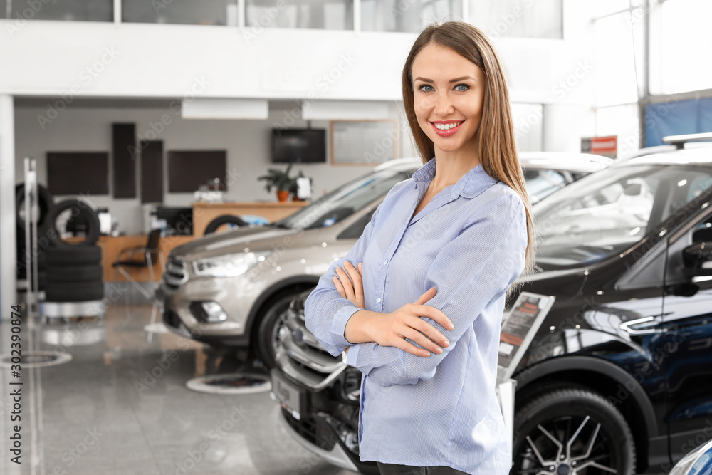 Beautiful young woman in car salon