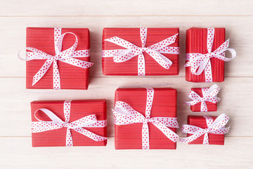 Red gift boxes with white ribbons packaged alike