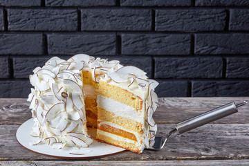 Sticker - sliced coconut cake on a wooden table