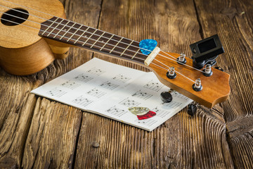 Ukulel with dice and notes on old boards