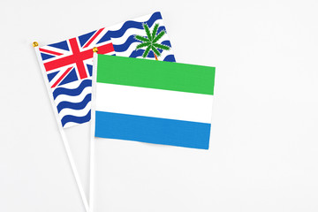 Sierra Leone and British Indian Ocean Territory stick flags on white background. High quality fabric, miniature national flag. Peaceful global concept.White floor for copy space.