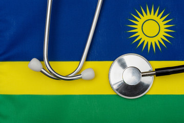 The flag of the country of Rwanda and stethoscope. The concept of medicine.