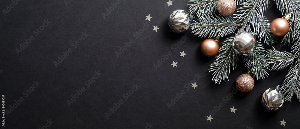 Christmas banner. Christmas tree branch decorated cooper and silver color balls on black background with confetti. Wide Xmas banner mockup, header, flyer - obrazy, fototapety, plakaty 