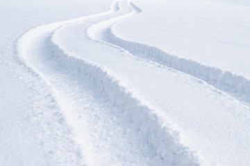 Car tracks in the deep fresh snow