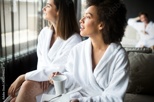 Fotomural Women relaxing and drinking tea in robes during wellness weekend