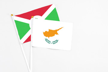 Wall Mural - Cyprus and Burundi stick flags on white background. High quality fabric, miniature national flag. Peaceful global concept.White floor for copy space.