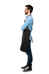 Wall Mural - Full-length shot of Man with apron in lateral position over isolated white background