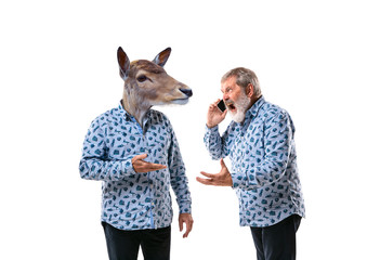 Portrait of senior man arguing with himself as a deer on white studio background. Concept of human emotions, expression, mental issues, internal conflict, split personality. Copyspace. Scream.