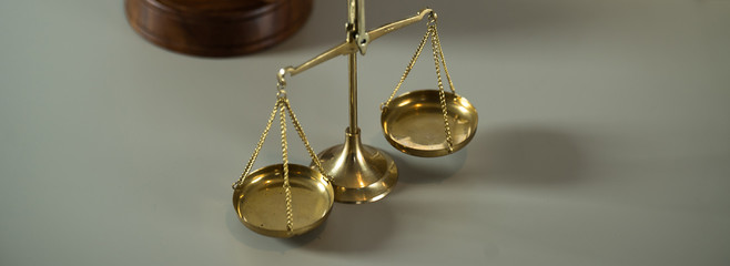 Law scales on wooden desk concept for justice and equality