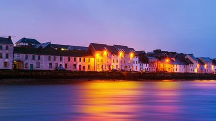 Wall Mural - Galway, Ireland. Beautiful landscape of Galway, Ireland. River and famous painted houses with cloudy colorful sky. Time-lapse during the sunrise, panning video