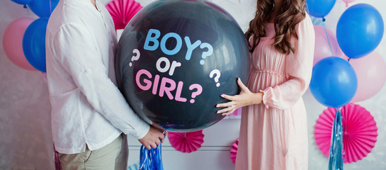 man and woman holding black balloon with 