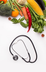 Wall Mural - Stethoscope and collection of fresh vegetables on white