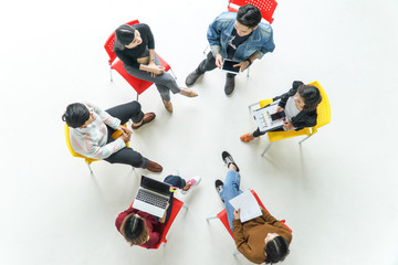 Top view of young people sitting in circle at the meeting.