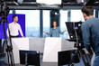 © New Africa - Presenters and video camera operator working in studio. News broadcasting