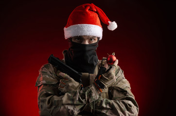 a man in a military uniform with a gun and a Santa Claus hat