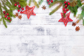 christmas background with fir tree, holly and decoration on wooden table. light bokeh. top view copy