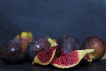 open natural black figs isolated on black background