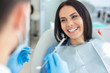 © Afshar Tetyana - smiling woman in dental chair with doctor holding dental mirror