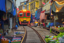 Rom Hoop Market. Thai Railway With A Local Train Run Through Mae Klong Market In Samut Songkhram Province, Thailand. Tourist Attraction In Travel And Transportation Concept.